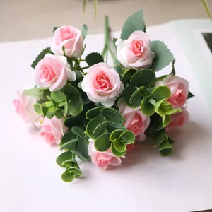 Close-up detail of artificial pink rose bouquet with eucalyptus leaves