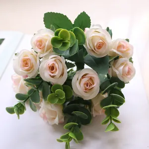 Close-up of artificial rose bouquet with pink cream blossoms and green eucalyptus leaves
