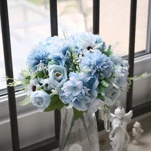 Close-up detail of a blue artificial flower bouquet featuring hydrangea and daisy petals