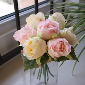 Close-up detail of realistic 7-head artificial silk rose bouquet in pink and yellow tones