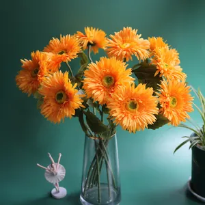 Vibrant orange artificial gerbera flowers in a clear glass vase for elegant home decor