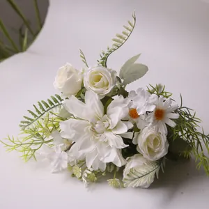 Detail view of artificial white dahlia, rose and daisy bouquet with green foliage texture