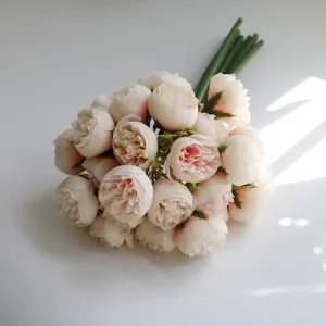 Close-up of a 27-head peach silk tea rose bouquet with realistic petal textures.