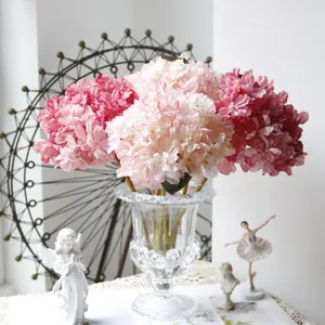 Elegant French vintage style artificial pink hydrangea flowers in clear glass vase