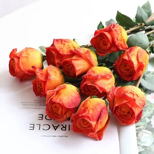 Detail shot of artificial burnt edge silk roses with vintage orange-red gradient