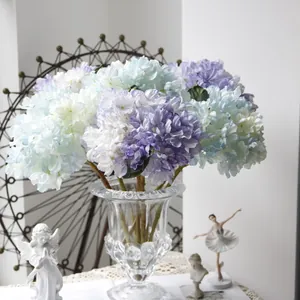 French vintage blue and purple artificial hydrangeas in a decorative glass vase