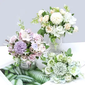 Beautiful assorted artificial rose and hydrangea bouquets in vases for home decor
