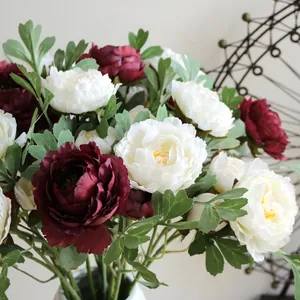Detail of lifelike burgundy and white silk peony artificial flowers for home wedding decor