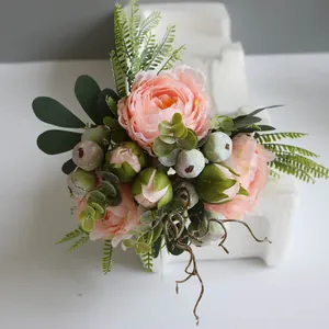 Close-up of elegant pink peony artificial flower bouquet with realistic greenery