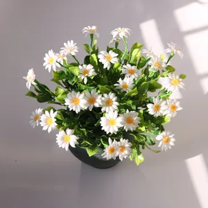 Close-up view of realistic white artificial daisy bouquet under natural window sunlight