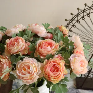 Close-up of elegant peach artificial silk peonies for home and wedding ceremony decor.