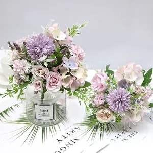 Macro detail of Nordic style artificial rose and hydrangea bouquet in a mini glass vase.