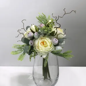 Elegant artificial peony bouquet with mixed berries in a clear glass vase for home decor