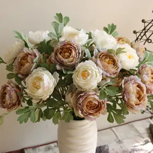 Detailed close-up of white and dusty mauve silk artificial peonies in a white ceramic vase