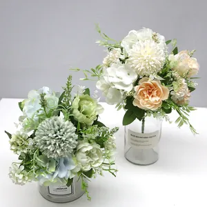 Detailed view of artificial hydrangea and rose bouquets in elegant glass vases decor