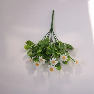 Close-up detail of 7-stem artificial white chamomile daisy bouquet with lush green leaves