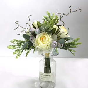 Detailed view of elegant cream Peony artificial flowers bouquet in a clear glass vase