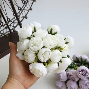 Detailed handheld view of a 27-head white artificial tea rose bouquet for home decor