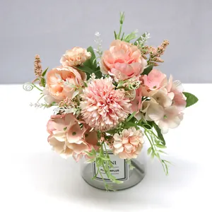Detailed macro shot of an elegant pink silk hydrangea and rose bouquet in a glass vase