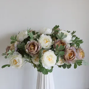 Detailed macro of elegant silk Ranunculus bouquet in a white fluted vase