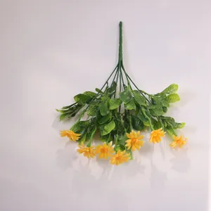 Detailed view of high-quality artificial yellow chamomile flowers with green leaves texture
