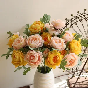 Detailed view of artificial silk peony flower petals in yellow and soft pink colors.