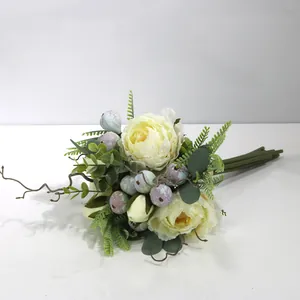 Detailed view of artificial peony bouquet with berries and greenery for home decor