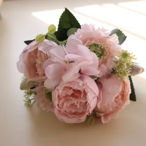 Primer plano de un ramo de peonías y hortensias artificiales rosas con luz natural y sombras