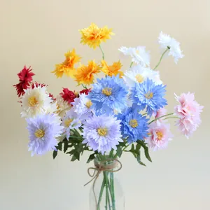 Vibrant multi-colored artificial chrysanthemum bouquet in a glass vase for home decor.