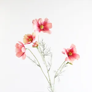 Primo piano di un fiore di cosmo artificiale rosa con petali delicati e stami gialli