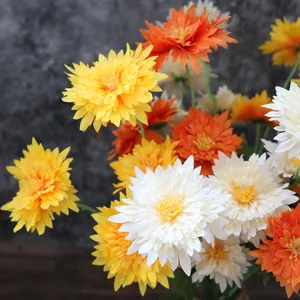 Close-up detail showing the realistic fabric texture of yellow and white faux chrysanthemums
