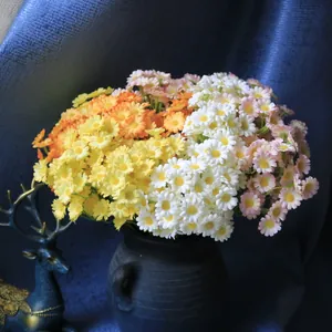 Vibrant multi-colored artificial daisy bouquet in a rustic vase for home decor