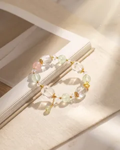 Detailansicht von weißem Quarz und hellgrünem Kristallperlenarmband mit Goldakzenten