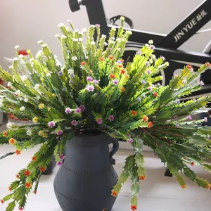 Detailed view of artificial Christmas cactus plant with colorful flowers in a rustic vase