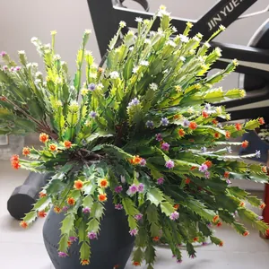 Close-up detail of artificial cactus plant with vibrant colorful flowers in black pot