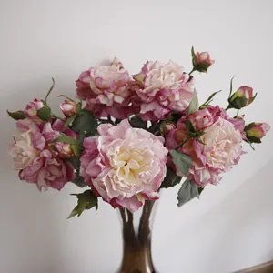 Detailed macro shot of elegant pink artificial peonies arranged in a glass vase