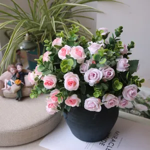 Close-up of artificial pink and purple rose bouquet in black ceramic pot