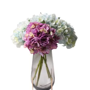 Realistic artificial hydrangea bouquet in a modern glass vase for home wedding decor