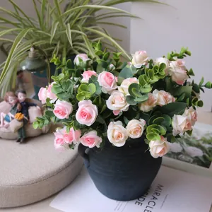Elegant artificial rose bouquet with eucalyptus leaves in a vintage blue ceramic vase
