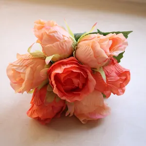 Close-up of vivid artificial orange and peach rose bouquet for wedding decoration