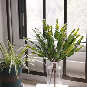 Realistic artificial cactus plant with purple flower tips in a clear glass vase for decor