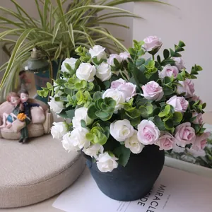 Close-up of pink and white artificial rose bouquet with eucalyptus in a blue pot