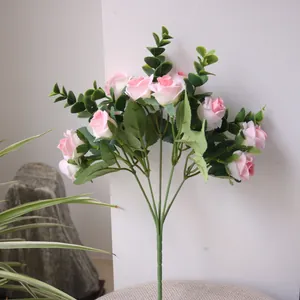 Artificial pink rose bouquet with eucalyptus leaves close-up view