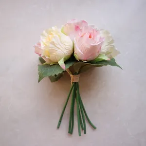 Close-up of artificial rose flower bouquet in pink and cream colors with green stems