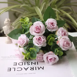 Detailed view of an artificial pink rose bouquet with green eucalyptus leaves for home