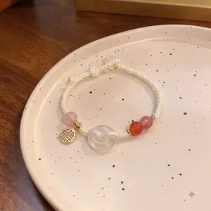 Handgefertigtes weißes geflochtenes Armband mit Rosenquarz und Jade-Friedensschnalle