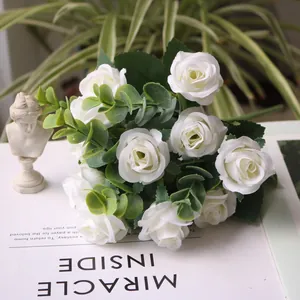 Detailed shot of white artificial rose bouquet with eucalyptus leaves for home decor