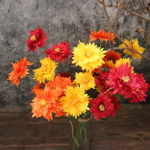 Detail view of vibrant multi-colored artificial woolly chrysanthemum flowers in a vase