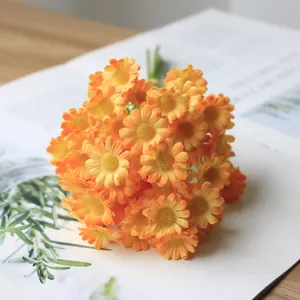 Close-up macro view of realistic orange artificial daisy bouquet for home decoration