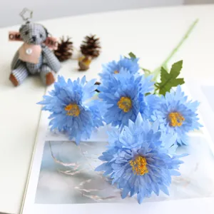 Close-up detail of blue artificial 5-headed chrysanthemum flowers for home decor.